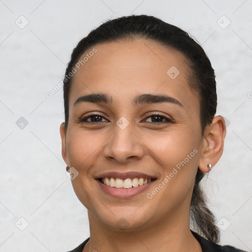 Joyful latino young-adult female with short  brown hair and brown eyes