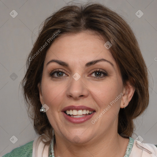 Joyful white adult female with medium  brown hair and blue eyes