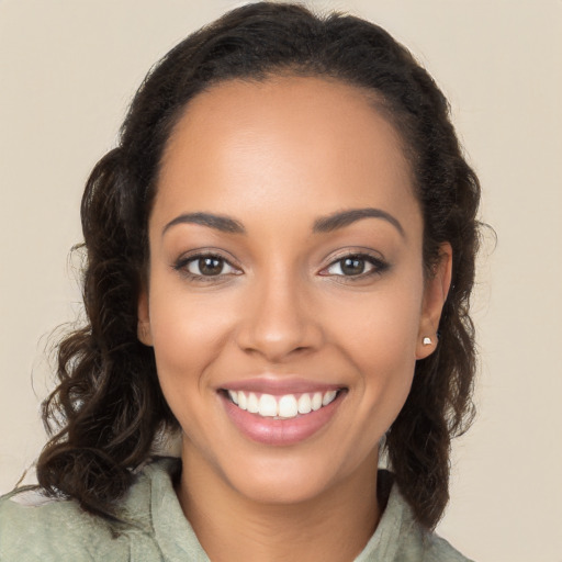 Joyful latino young-adult female with long  brown hair and brown eyes