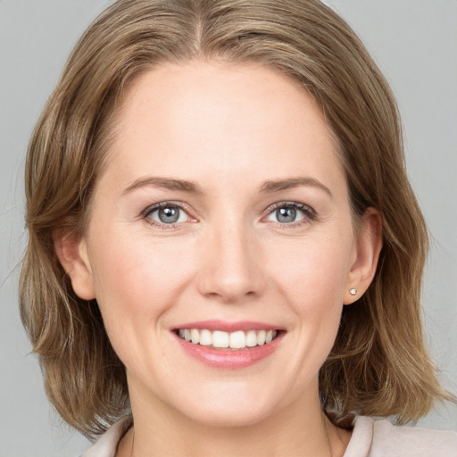 Joyful white young-adult female with medium  brown hair and blue eyes