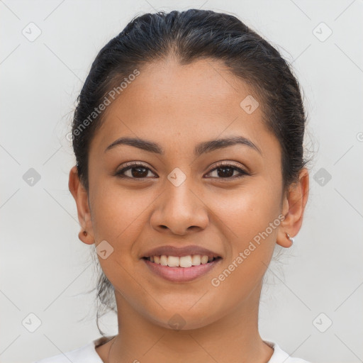 Joyful latino young-adult female with medium  brown hair and brown eyes