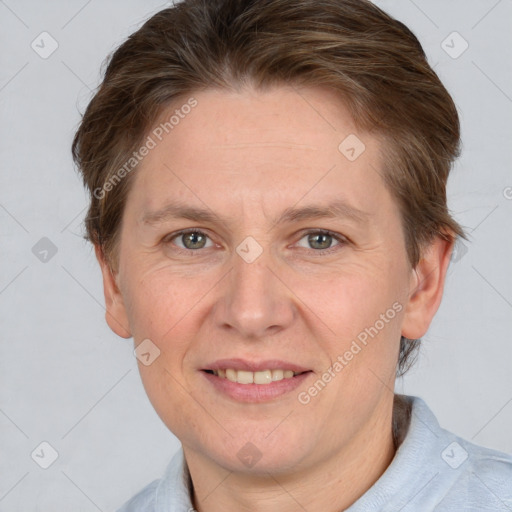 Joyful white adult female with short  brown hair and grey eyes