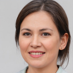 Joyful white young-adult female with medium  brown hair and brown eyes