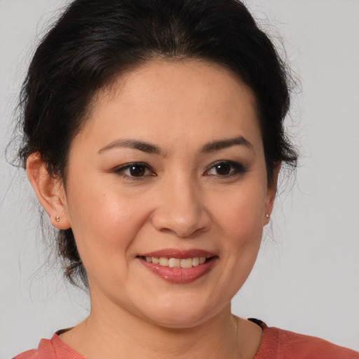 Joyful white adult female with medium  brown hair and brown eyes