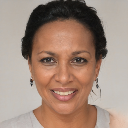 Joyful black adult female with short  brown hair and brown eyes