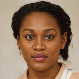 Joyful black adult female with medium  brown hair and brown eyes