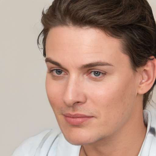 Joyful white young-adult male with medium  brown hair and brown eyes