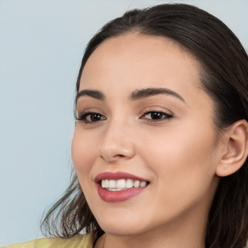 Joyful white young-adult female with long  black hair and brown eyes