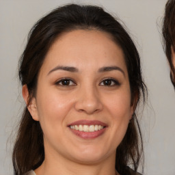 Joyful white young-adult female with medium  brown hair and brown eyes