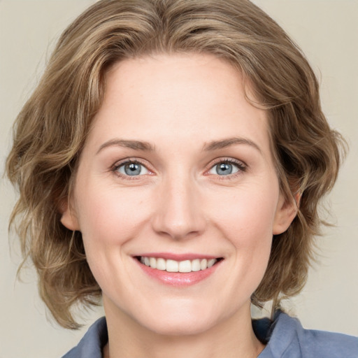 Joyful white young-adult female with medium  brown hair and blue eyes