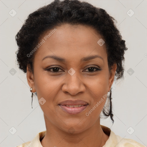 Joyful black adult female with short  brown hair and brown eyes