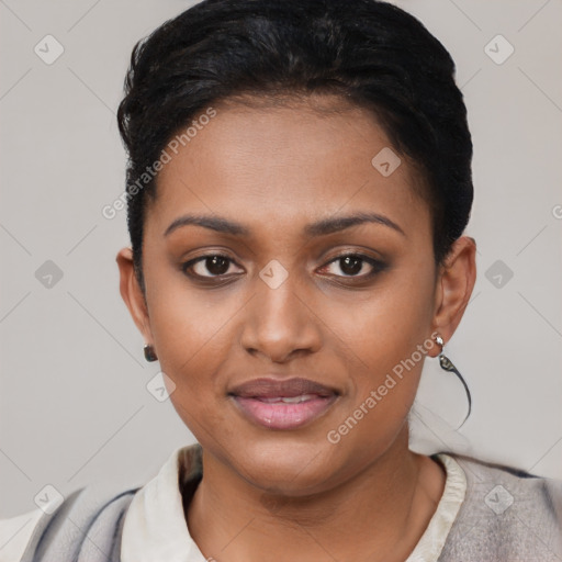 Joyful black young-adult female with short  black hair and brown eyes