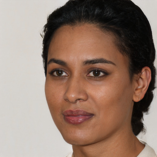 Joyful latino young-adult female with short  black hair and brown eyes