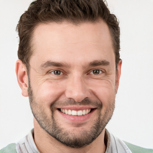 Joyful white adult male with short  brown hair and grey eyes