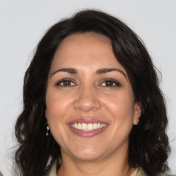 Joyful white adult female with long  brown hair and brown eyes