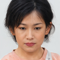 Neutral asian young-adult female with medium  brown hair and brown eyes