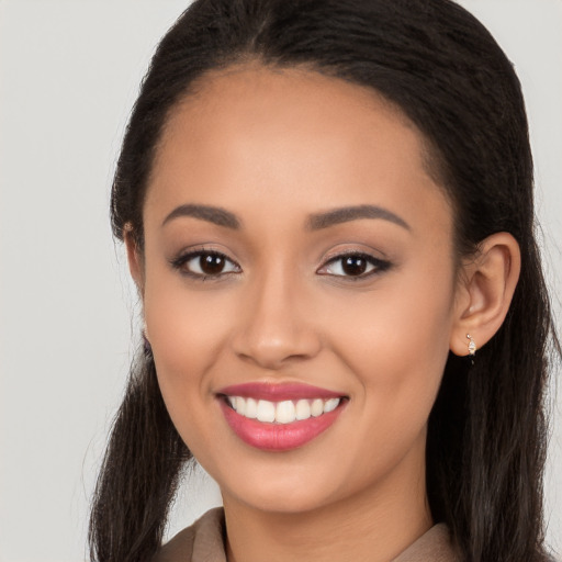 Joyful white young-adult female with long  black hair and brown eyes