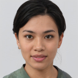 Joyful asian young-adult female with short  black hair and brown eyes