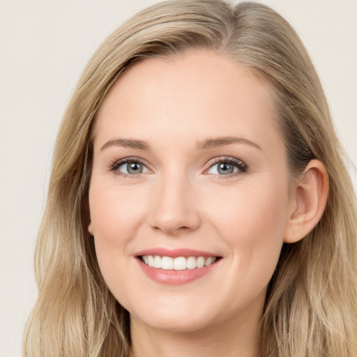 Joyful white young-adult female with long  brown hair and blue eyes