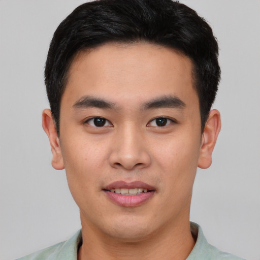 Joyful asian young-adult male with short  black hair and brown eyes