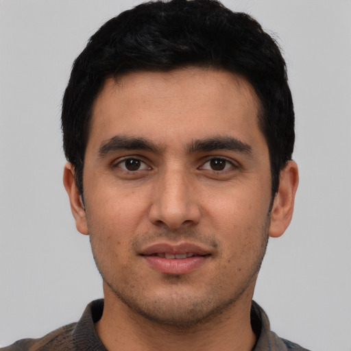 Joyful white young-adult male with short  black hair and brown eyes