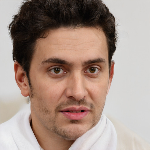 Joyful white adult male with short  brown hair and brown eyes