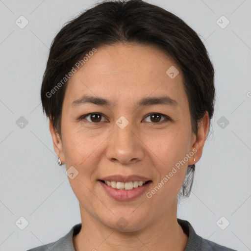 Joyful asian adult female with short  brown hair and brown eyes