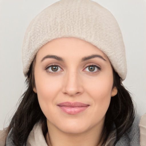 Joyful white young-adult female with medium  black hair and brown eyes