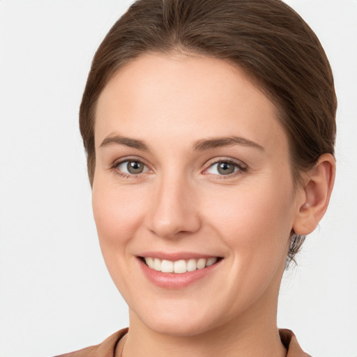 Joyful white young-adult female with short  brown hair and grey eyes