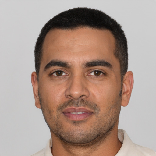 Neutral latino young-adult male with short  black hair and brown eyes