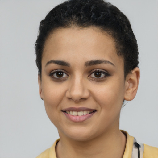 Joyful latino young-adult female with short  black hair and brown eyes