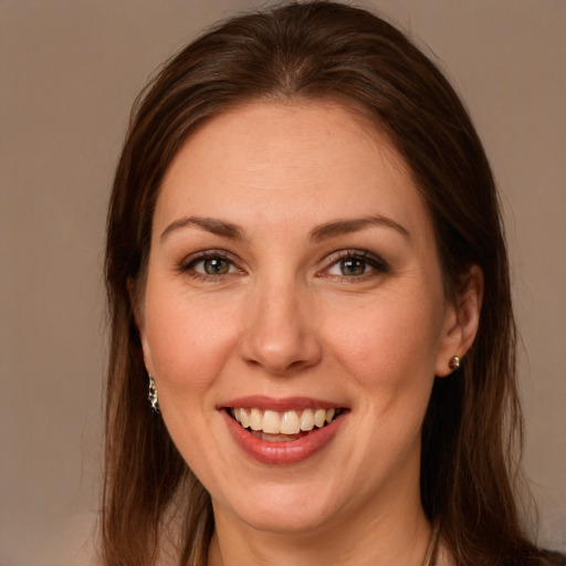 Joyful white young-adult female with long  brown hair and grey eyes