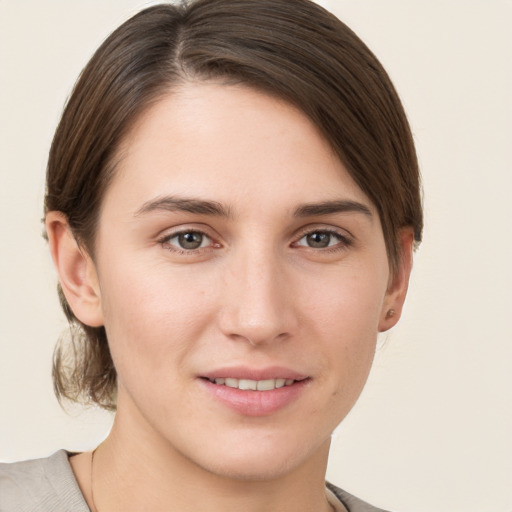 Joyful white young-adult female with short  brown hair and grey eyes