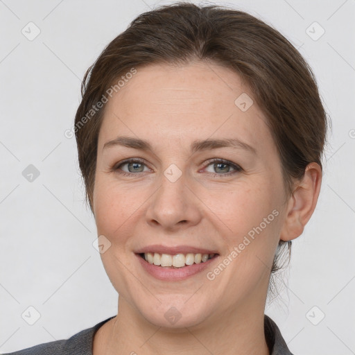 Joyful white adult female with medium  brown hair and grey eyes