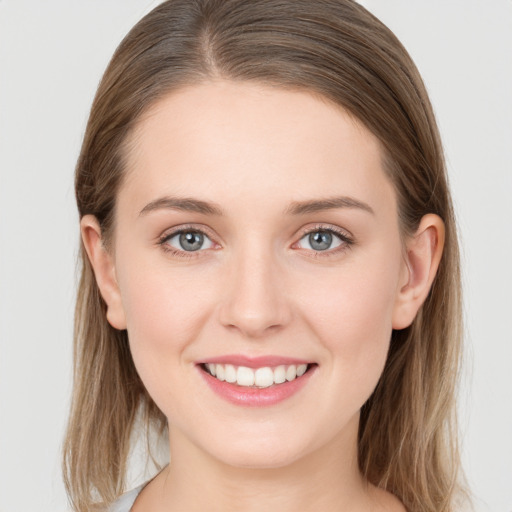 Joyful white young-adult female with long  brown hair and grey eyes