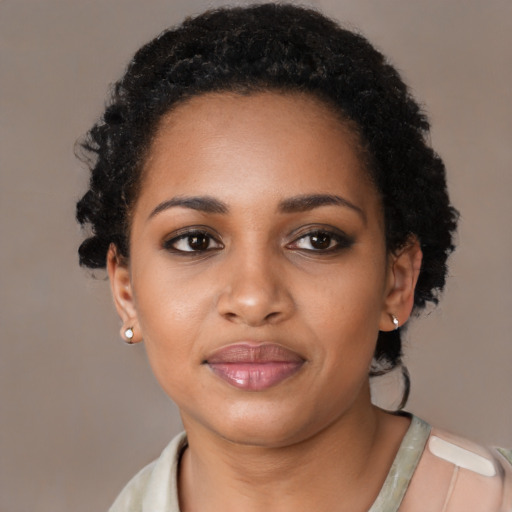 Joyful latino young-adult female with short  black hair and brown eyes