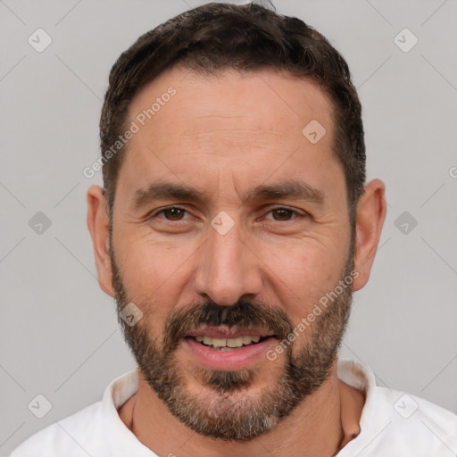 Joyful white adult male with short  brown hair and brown eyes