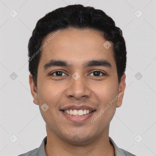 Joyful latino young-adult male with short  black hair and brown eyes