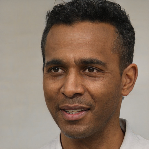 Joyful latino adult male with short  black hair and brown eyes
