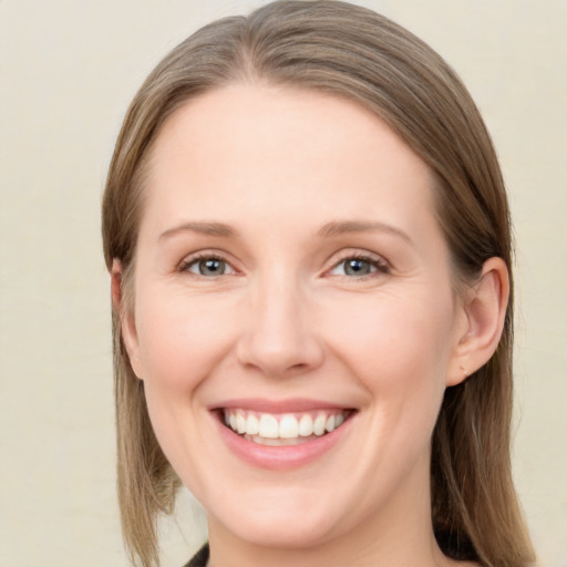 Joyful white young-adult female with medium  brown hair and green eyes