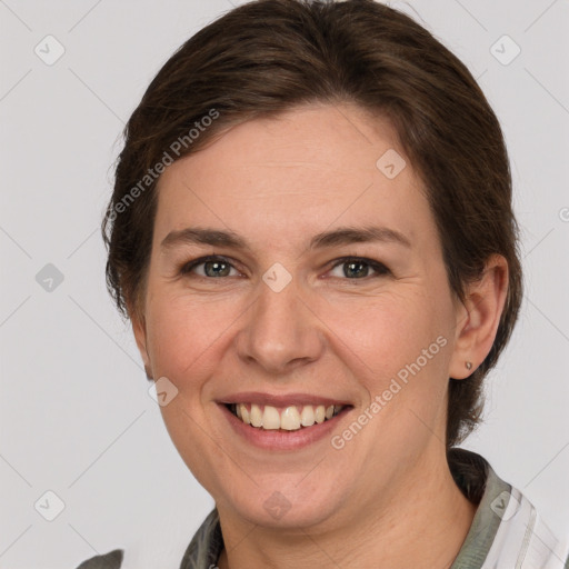 Joyful white adult female with medium  brown hair and grey eyes