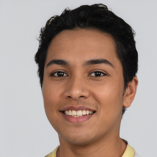 Joyful latino young-adult male with short  black hair and brown eyes