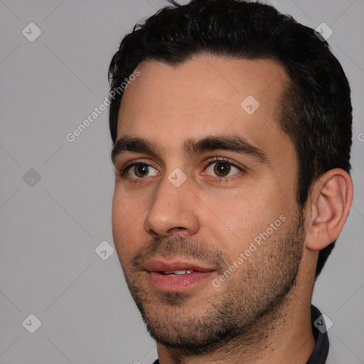 Joyful white young-adult male with short  black hair and brown eyes