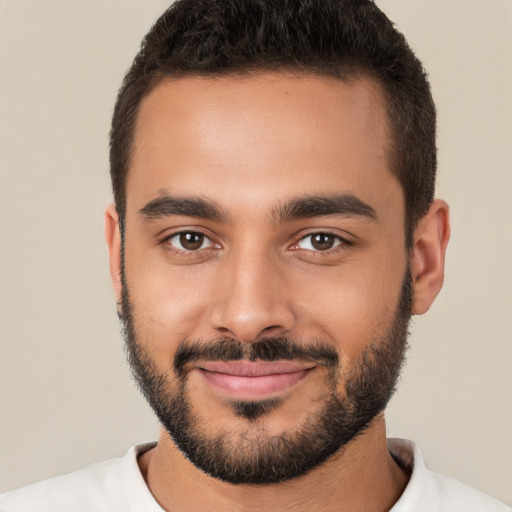 Joyful white young-adult male with short  black hair and brown eyes