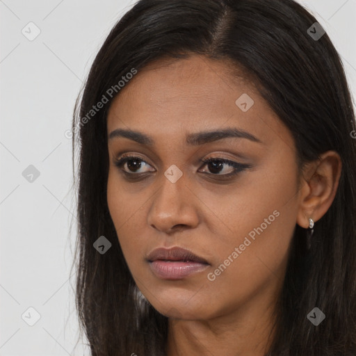 Joyful black young-adult female with long  brown hair and brown eyes