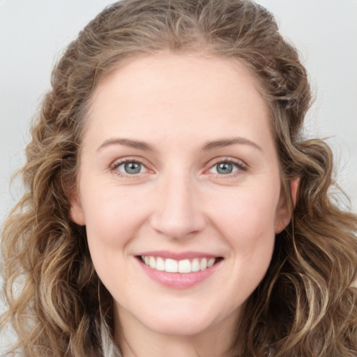 Joyful white young-adult female with long  brown hair and green eyes