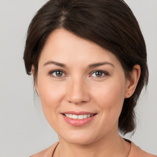 Joyful white young-adult female with medium  brown hair and grey eyes