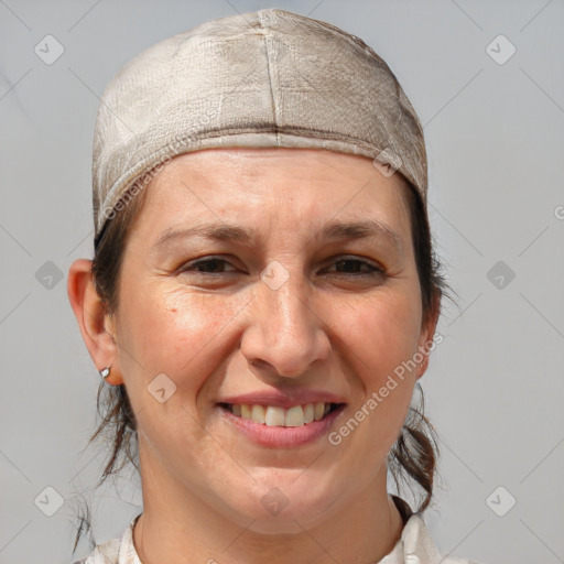 Joyful white adult female with medium  brown hair and grey eyes