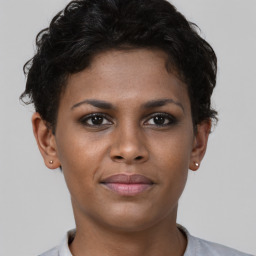 Joyful black young-adult female with short  brown hair and brown eyes