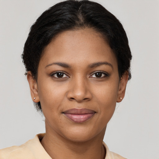 Joyful black young-adult female with short  brown hair and brown eyes